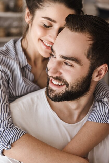 Close up of a happy couple hugging indoors