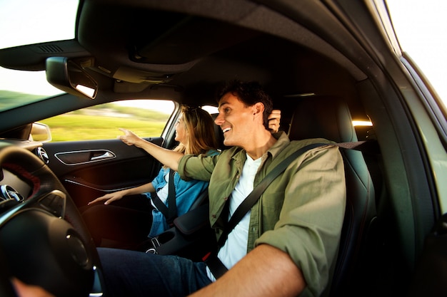 Close up happy couple sightseeing on road trip together