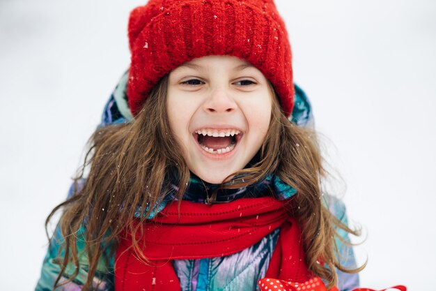 Close up of the happy cute girl looking at the camera and smiling