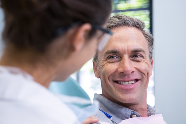 Close up of happy patient looking at dentist