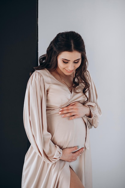 close up of happy pregnant woman with big belly