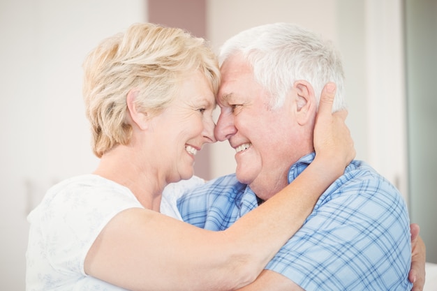 Close-up of happy senior couple embracing