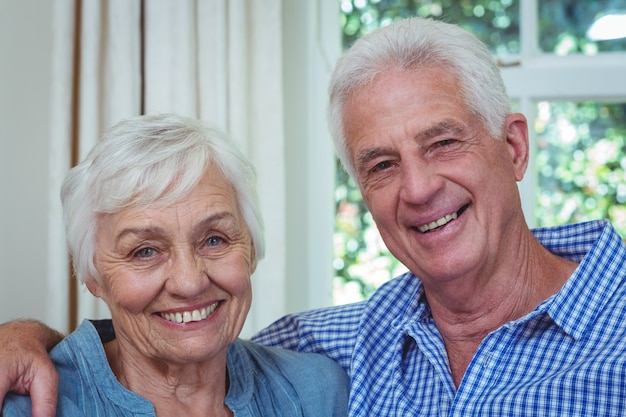 Close-up happy senior couple with arm around 