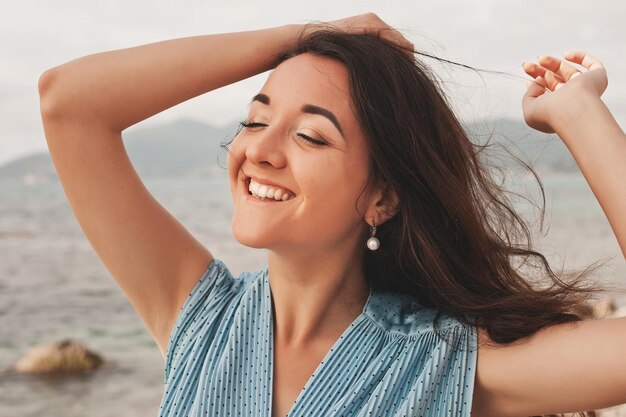 海の夏休みの近くで幸せな女性を閉じる