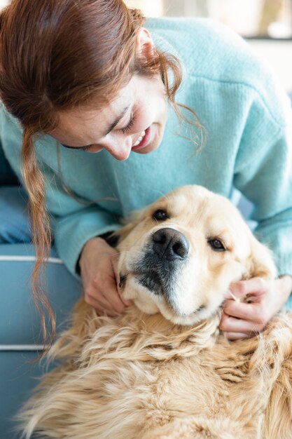 Close up happy woman playing with dog