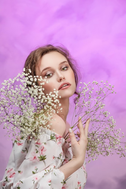 Close up of happy woman smelling wild flowers Female being with nature