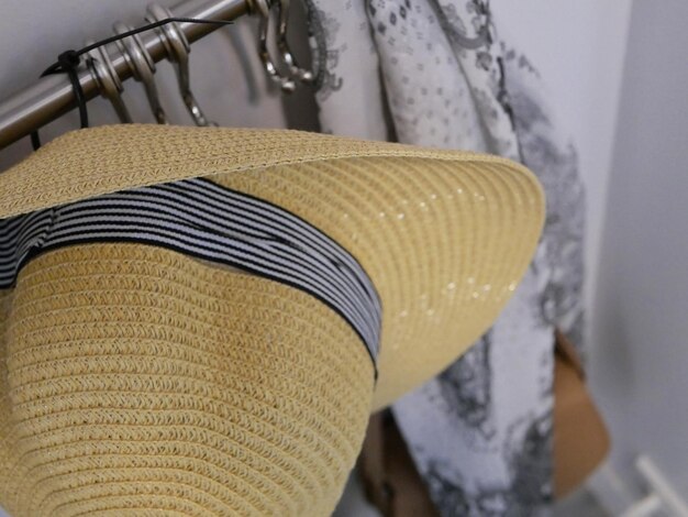 Photo close-up of hat hanging on rack