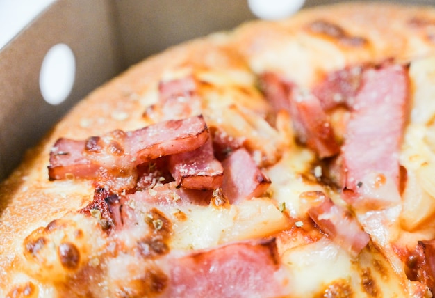 Close up of hawaiian pizza with boiled ham and pineapple.