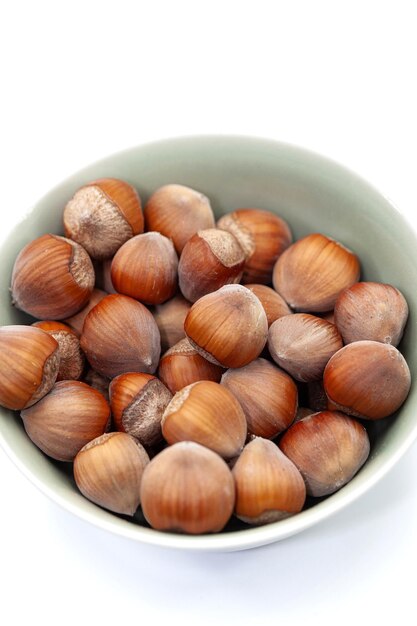 Close up of hazelnuts in a green bowl