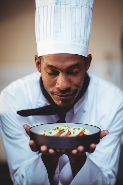 Close-up of head chef presenting salad