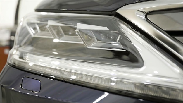 Close up for the headlights of the black new polished car luxury concept action modern car