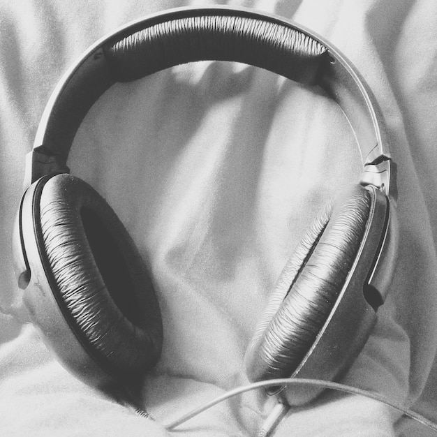 Photo close-up of headphones on bed at home