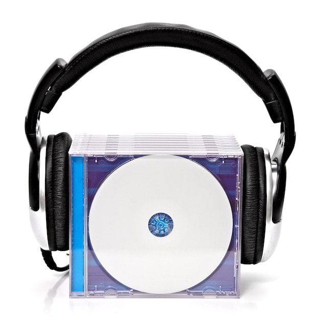 Photo close-up of headphones and compact disc against white background