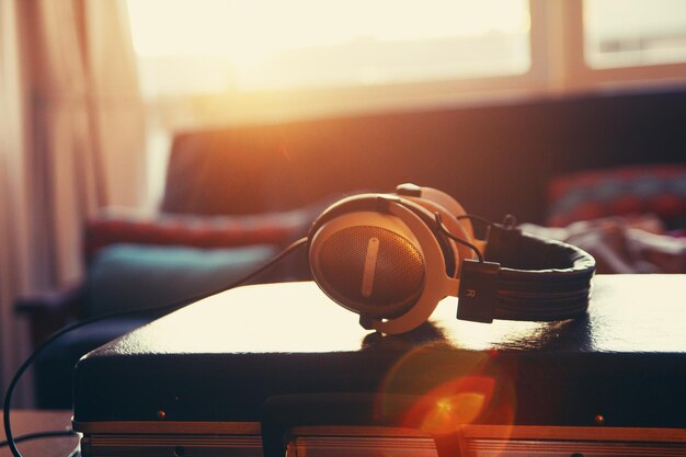 Photo close-up of headphones on suitcase at home