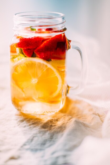 Photo close-up of healthy drink in glass jar on table