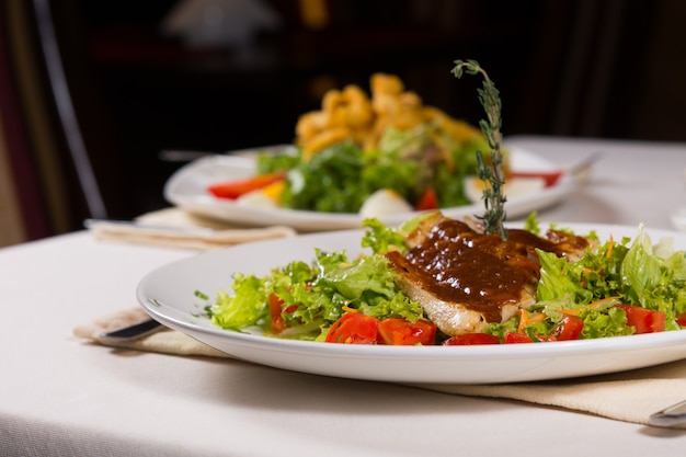 Close up Healthy Main Dish Recipe with Meat and Vegetables on White Round Plate Served at the Restaurant During Dinner.