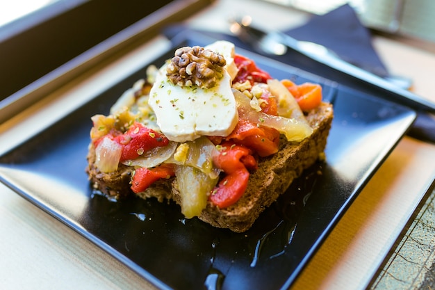 Close-up of healthy sandwich with fruits and nuts in a restaurant.