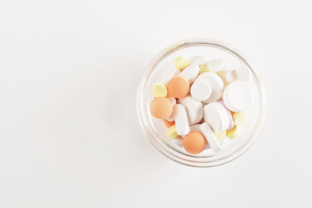 Close up of heap of pills with pill bottle