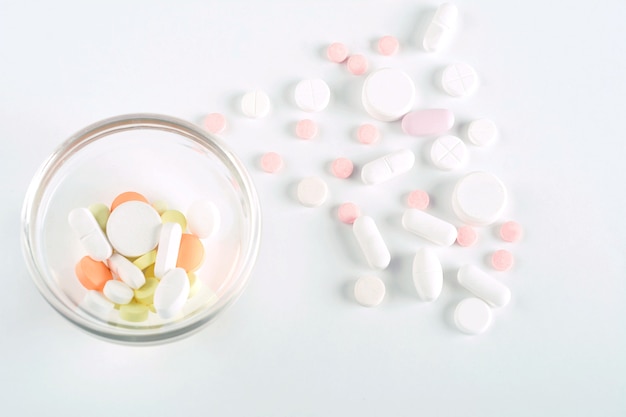 Close up of heap of pills with pill bottle