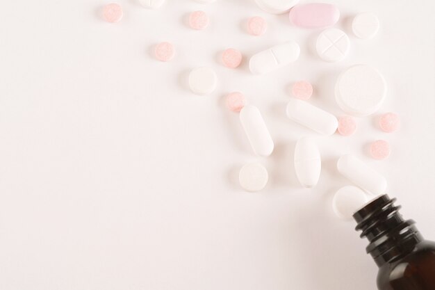 Close up of heap of pills with pill bottle