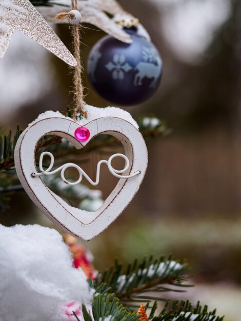 Photo close-up of heart shape hanging on christmas tree