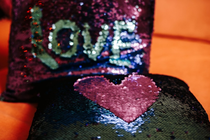 Photo close-up of heart shape and love text on pillows