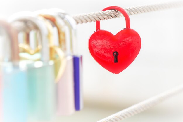 Close-up of heart shape padlocks hanging on rope