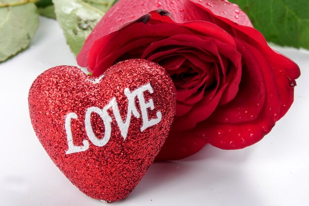 Close-up of heart shape and rose on table