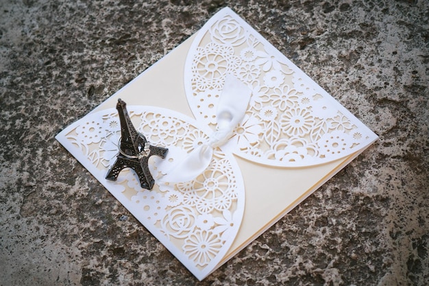 close-up high angle view of eiffel tower and wedding card on floor