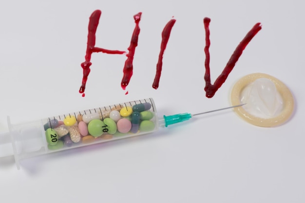 Close-up of hiv in blood by syringe over white background