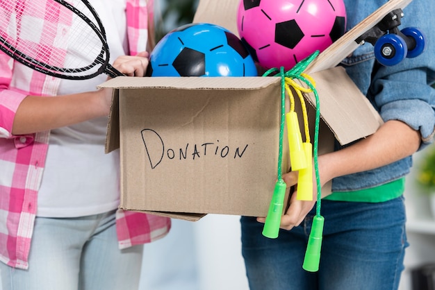 Photo close-up holding donation box