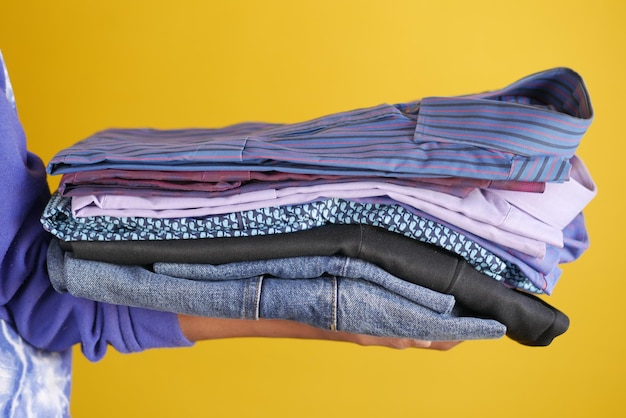 Close up of holding stack of cloths on table