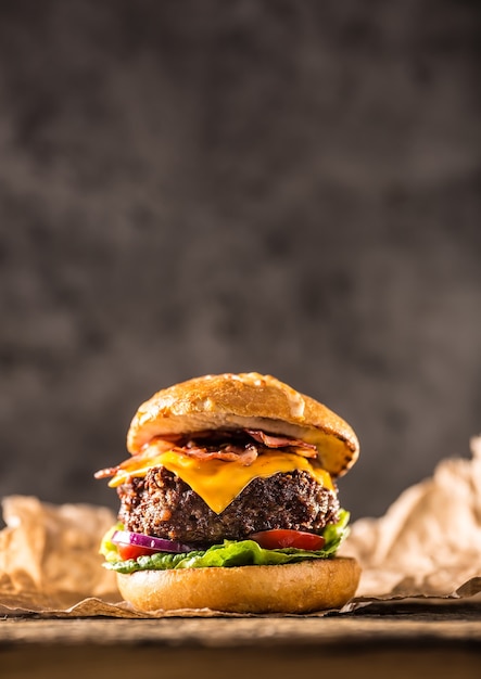 Close-up home made beef burger on wooden table.