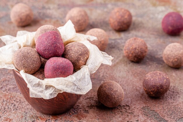 Close Up of Homemade Raw Vegan Cacao Energy Balls in Bowl with Craft Paper