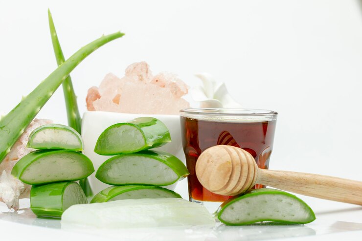 Close-up of honey and aloe against white background