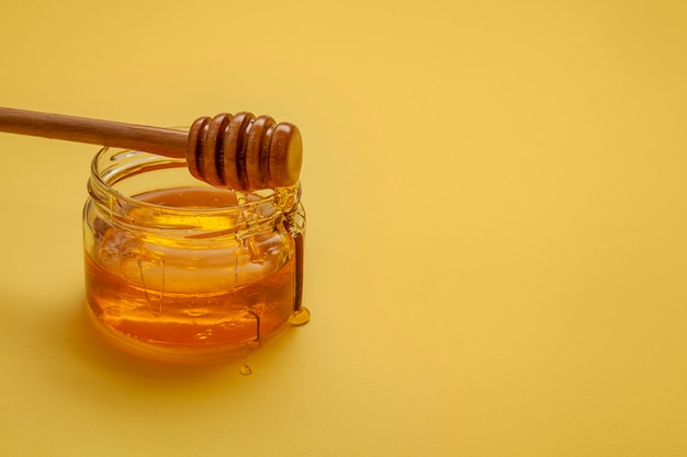 Close-up honey stick on top of bowl