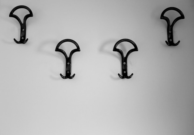 Photo close-up of hooks mounted on white wall