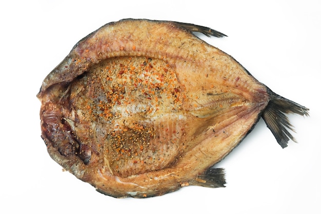 Close up horizontal view of smoked fish fillets with seasoning.