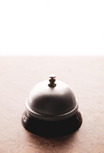 Close up of hotel bell on reception table, copy space