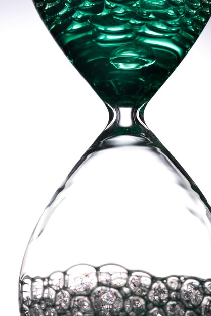 Close-up of hourglass on white background