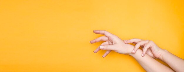 Close-up of human hand against yellow background