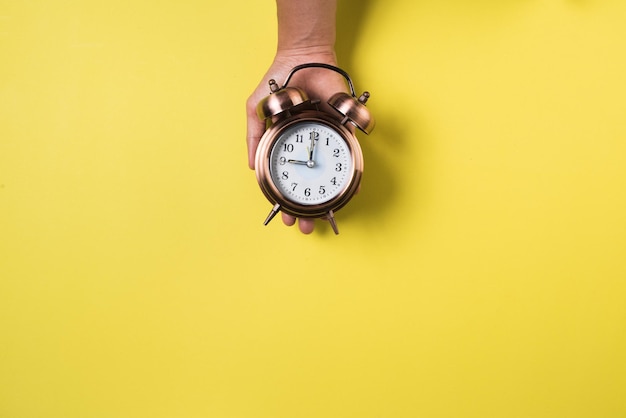 Close-up of human hand against yellow background