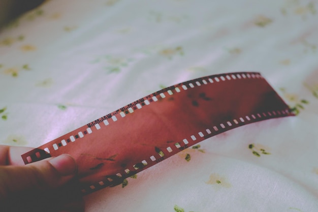 close-up of human hand holding negatives