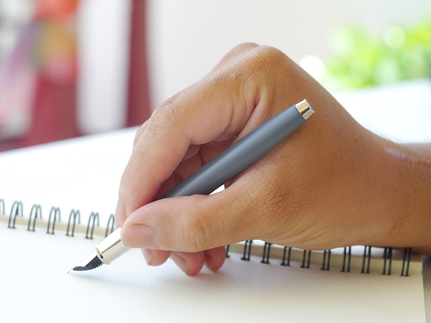 Close up of human hand with pen