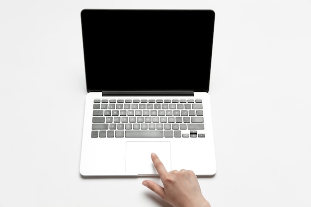 Photo close up of human hands using laptop isolated on white background. top view. copyspace, blank screen. surfing, online shopping, scrolling, betting, working. education and business concept.