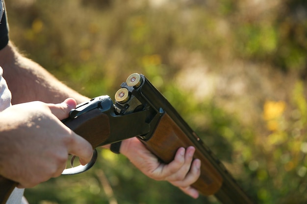 Close up on hunter holding a hunting rifle