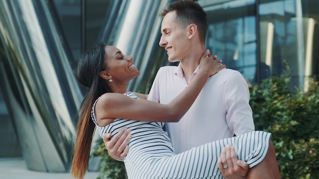 Close-up of husband holding in arms  his wife outdoors