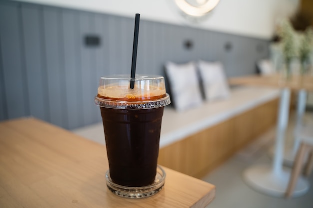 Close up of ice coffee on the wood table in the cafe