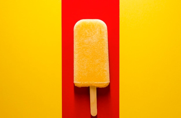 Close-up of ice cream cone against yellow background