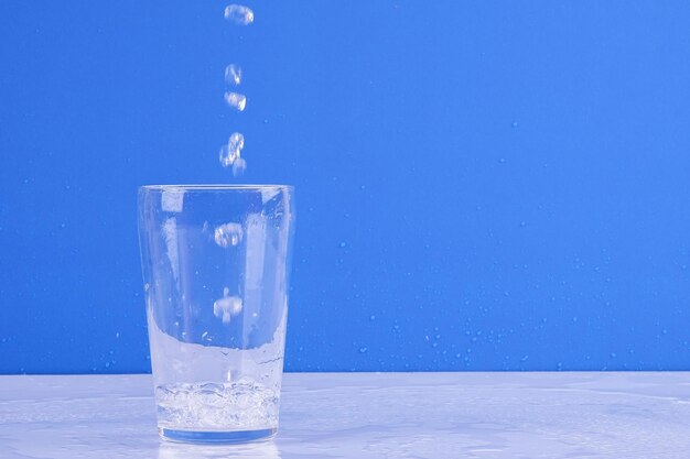 Close-up of ice crystals on table against blue background